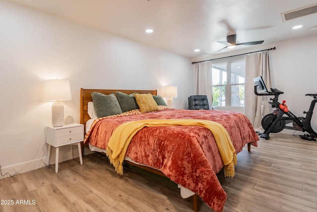 bedroom featuring light wood-type flooring, visible vents, baseboards, and recessed lighting