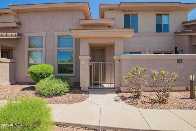 42424 N Gavilan Peak Pkwy Unit 57104, Anthem, AZ 85086 - view of front facade with a fenced front yard and stucco siding