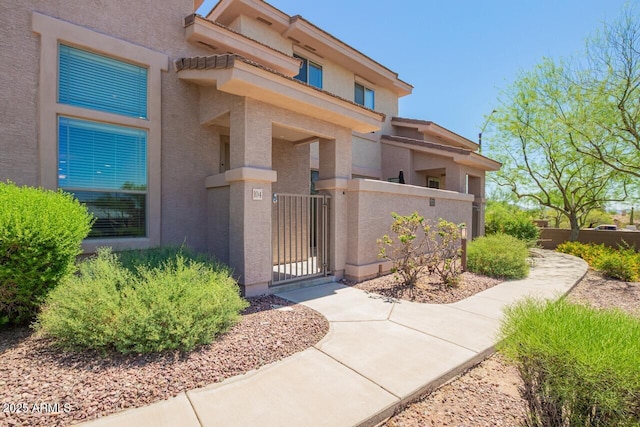 42424 N Gavilan Peak Pkwy Unit 57104, Anthem, AZ 85086 - view of exterior entry with stucco siding and a gate