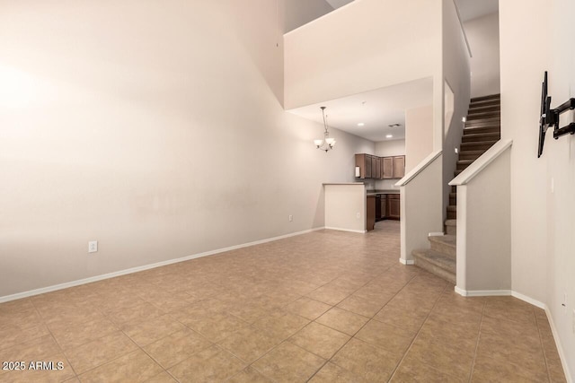 42424 N Gavilan Peak Pkwy Unit 57104, Anthem, AZ 85086 - unfurnished living room featuring stairs, a chandelier, and light tile patterned floors