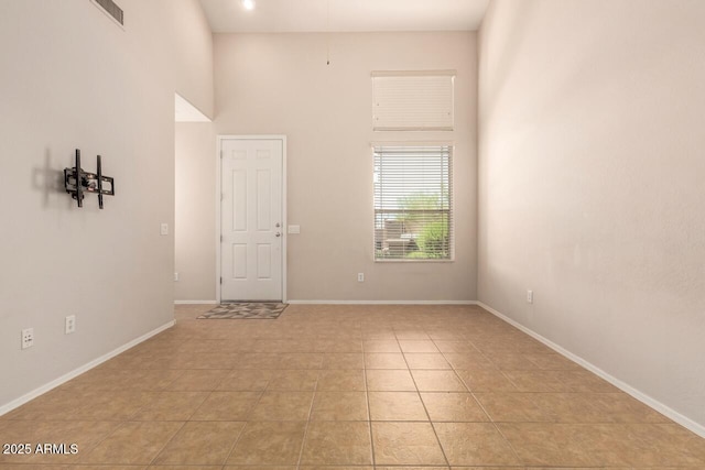 42424 N Gavilan Peak Pkwy Unit 57104, Anthem, AZ 85086 - spare room featuring light tile patterned flooring and a high ceiling