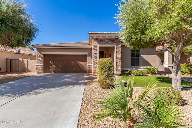 view of front of house with a garage and a front lawn