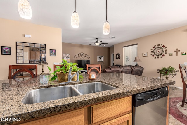 kitchen featuring stone counters, sink, dishwasher, ceiling fan, and pendant lighting