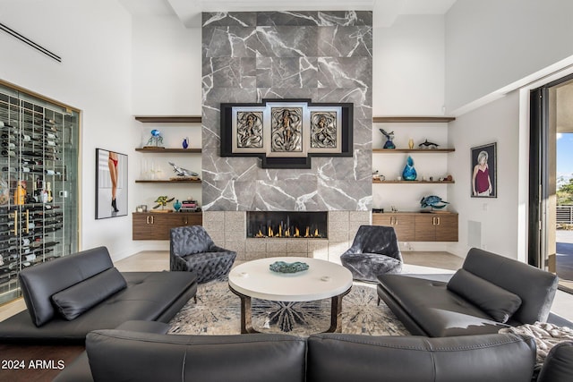 living room featuring a stone fireplace