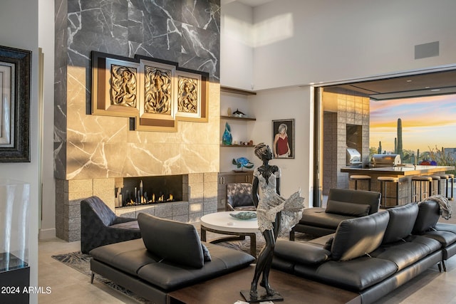 living room with tile walls and a fireplace