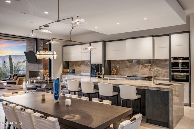 dining room with sink and a tile fireplace