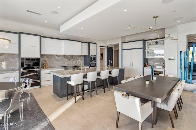 dining room featuring sink and light tile floors