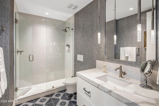 bathroom with a shower with door, toilet, tile floors, and large vanity