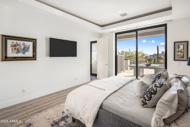 bedroom featuring hardwood / wood-style floors and access to exterior