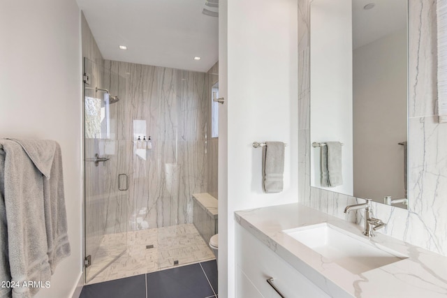 bathroom featuring tile floors, vanity, toilet, and walk in shower