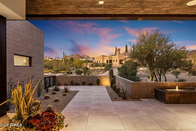 view of patio terrace at dusk