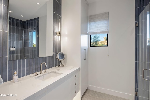 bathroom with backsplash, an enclosed shower, tile floors, and vanity