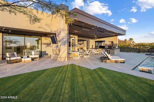 back of house with a patio area, a yard, and a fenced in pool