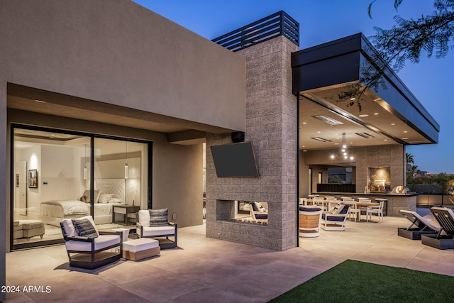 view of patio / terrace with an outdoor living space with a fireplace