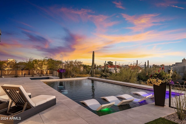 view of pool at dusk