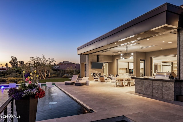 view of patio terrace at dusk