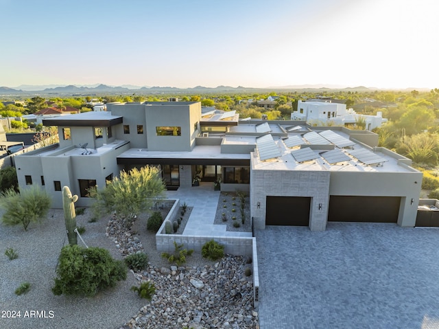 view of front facade with a mountain view and a garage