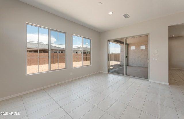 unfurnished room with light tile patterned floors, visible vents, baseboards, and recessed lighting