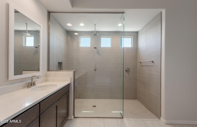 full bath featuring recessed lighting, tile patterned flooring, tiled shower, and vanity