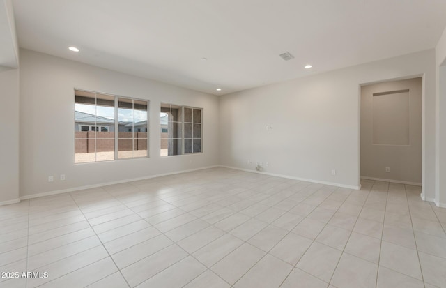 spare room featuring light tile patterned floors, visible vents, baseboards, and recessed lighting