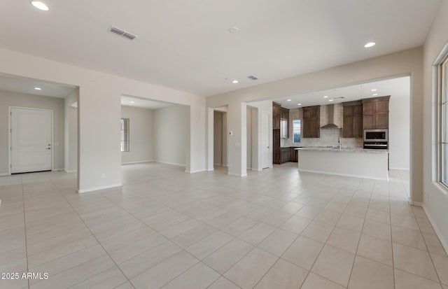 unfurnished living room featuring recessed lighting, visible vents, baseboards, and light tile patterned floors