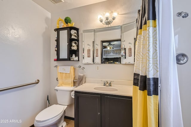 bathroom with vanity, walk in shower, ceiling fan, and toilet