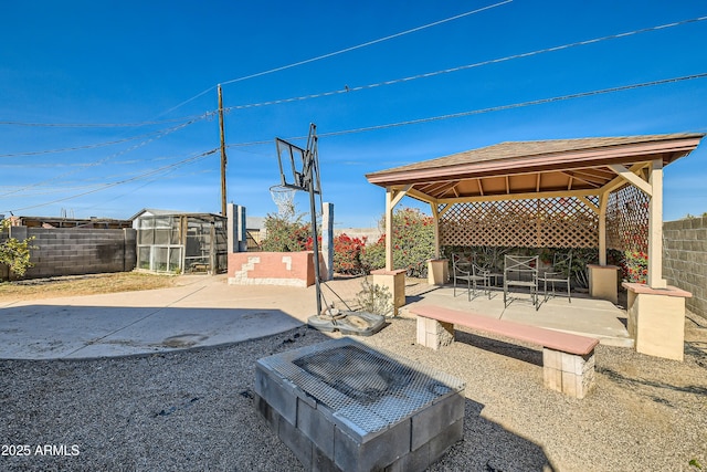 view of patio featuring a gazebo and an outbuilding