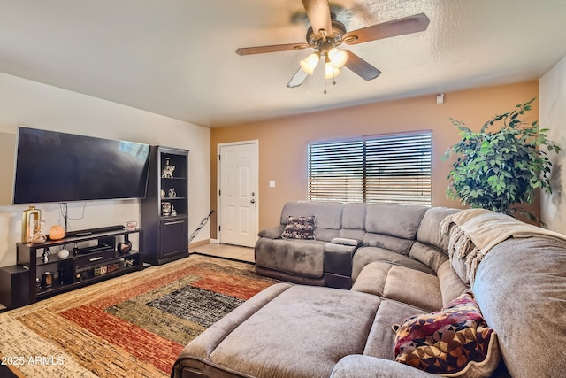 living room featuring ceiling fan and tile patterned flooring