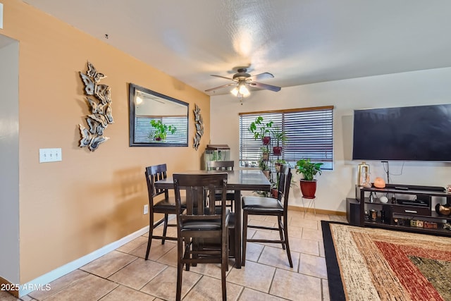 tiled dining room featuring ceiling fan