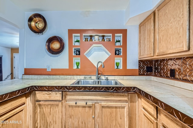 kitchen featuring light brown cabinetry, sink, and decorative backsplash