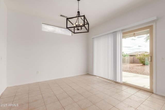 empty room featuring light tile patterned floors, visible vents, and a chandelier