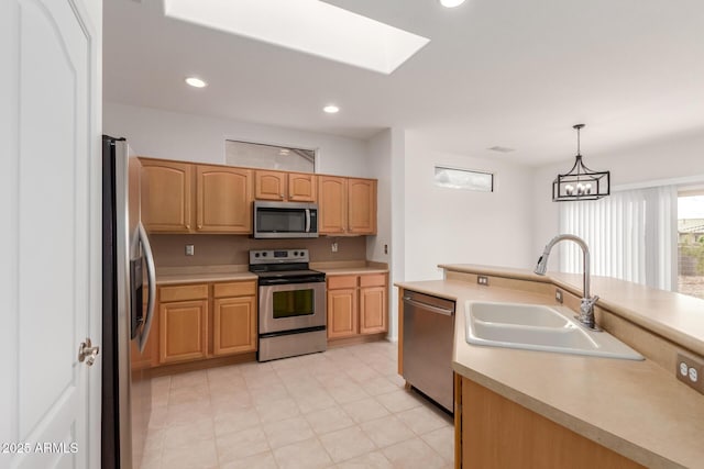 kitchen featuring light brown cabinets, recessed lighting, a sink, stainless steel appliances, and light countertops