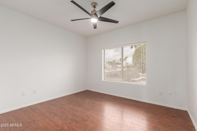 unfurnished room with baseboards, ceiling fan, and wood finished floors