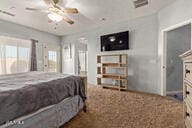 bedroom featuring ceiling fan and a fireplace