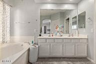 bathroom with a bathing tub and vanity