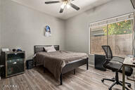 bedroom featuring ceiling fan and wood-type flooring