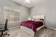 bedroom with ceiling fan and hardwood / wood-style floors