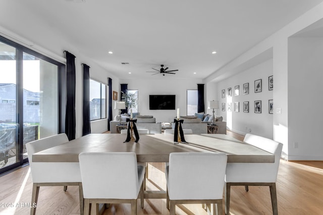 dining room with light wood-type flooring and ceiling fan