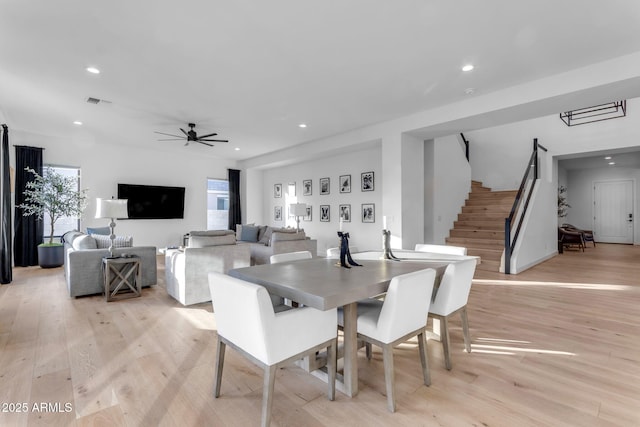 dining space featuring ceiling fan and light hardwood / wood-style flooring