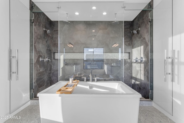 bathroom featuring tile patterned floors, a shower with shower door, and tile walls