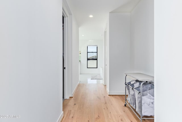 hallway with light hardwood / wood-style floors