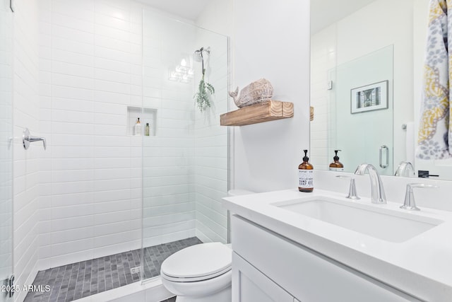 bathroom with vanity, toilet, and an enclosed shower