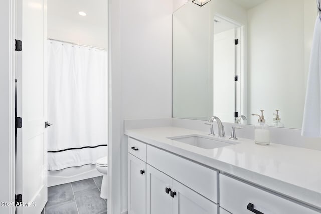 full bathroom with tile patterned floors, shower / bath combo with shower curtain, vanity, and toilet