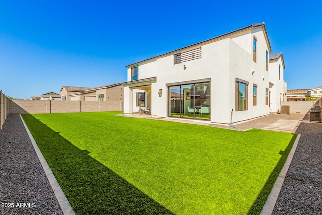 back of property with a lawn, a patio area, and central AC