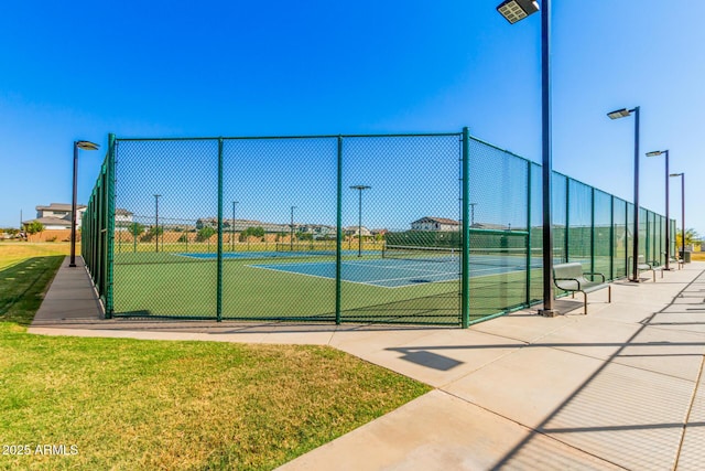 view of sport court featuring a yard