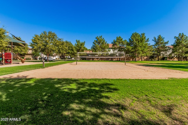 view of community featuring a lawn, a playground, and volleyball court