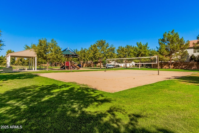 view of home's community with volleyball court, a yard, and a playground