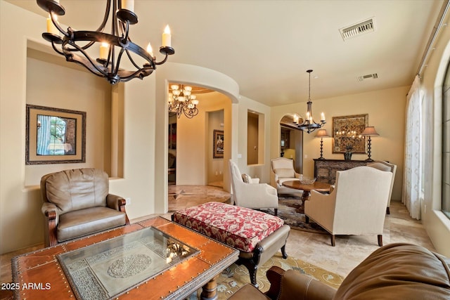 living room featuring visible vents, arched walkways, and a chandelier