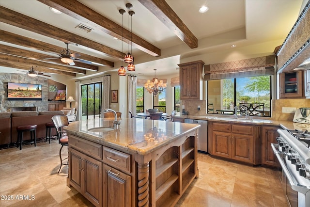 kitchen with a sink, appliances with stainless steel finishes, tasteful backsplash, and visible vents