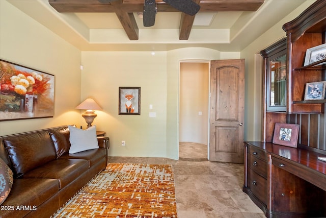 living area featuring ceiling fan and beam ceiling